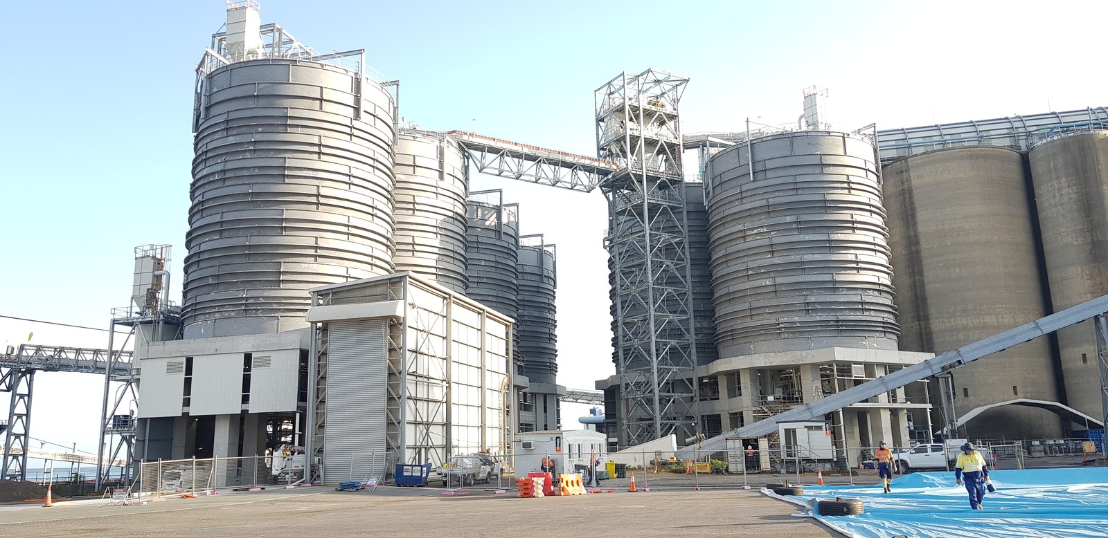 Completed industrial silos linked by material handling structures