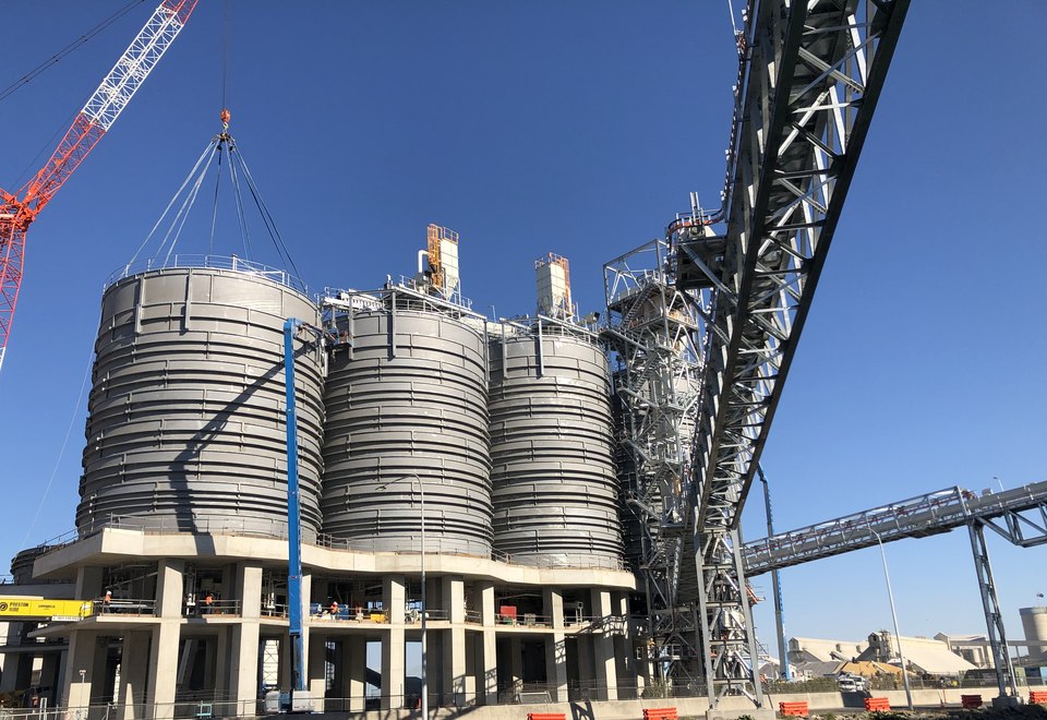 Large industrial silos during crane-assisted installation