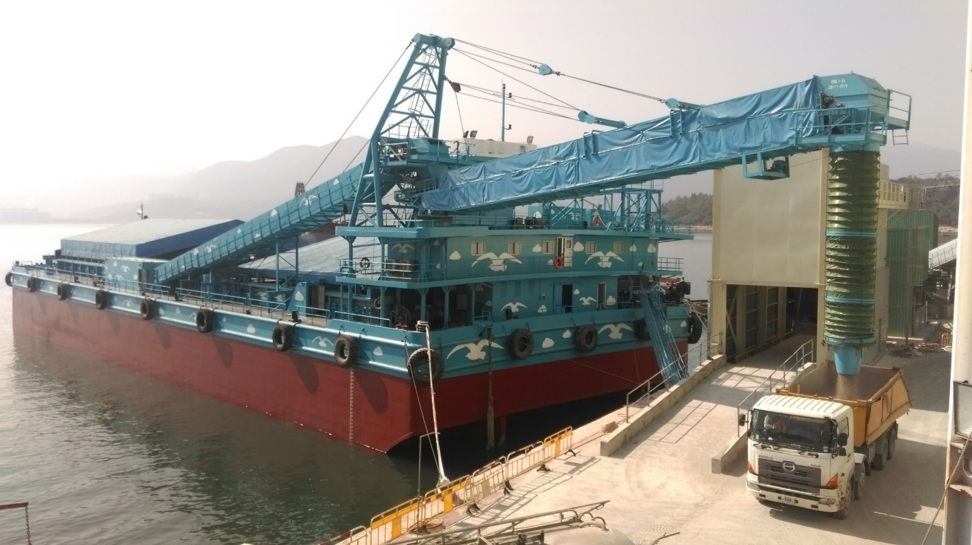 Aggregate handling barge unloading to a truck loading station in Hong Kong