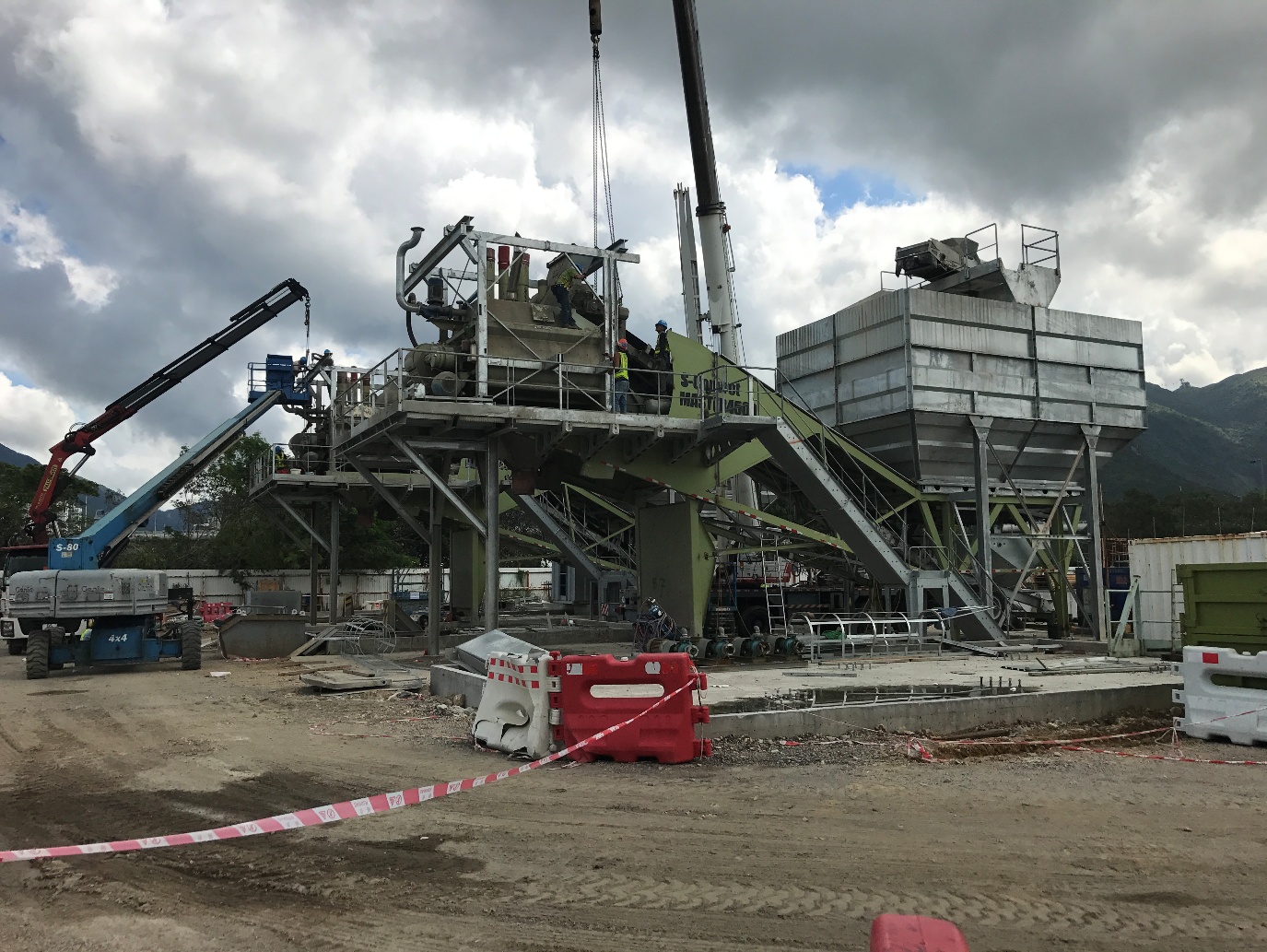 Mobile batching plant being assembled by cranes on a Hong Kong site