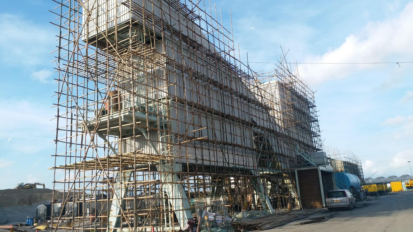 Industrial plant structure surrounded by scaffolding during demolition work in Hong Kong