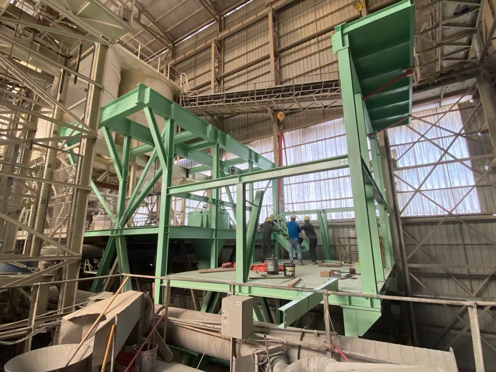 Additional green production equipment being installed inside an operating plant in mainland China